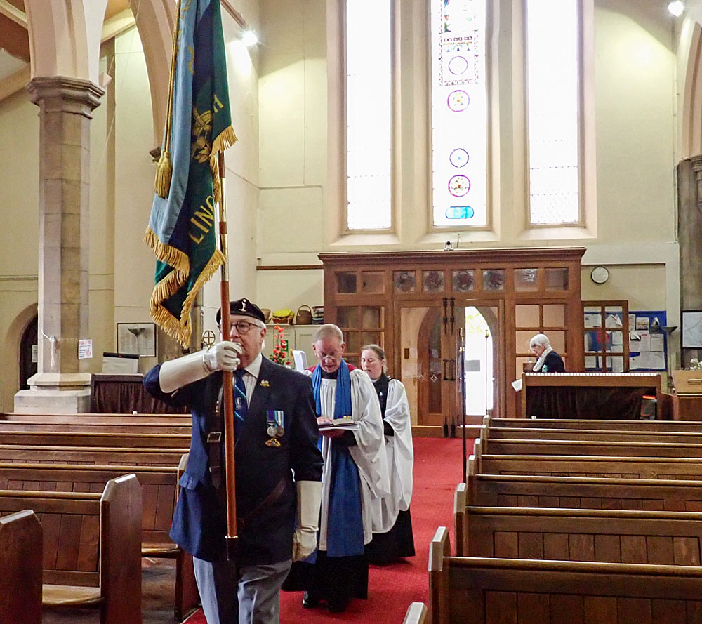6. Our Standard Bearer, Ben Revell, leads Neill &amp; Kate through the nave to the chancel.