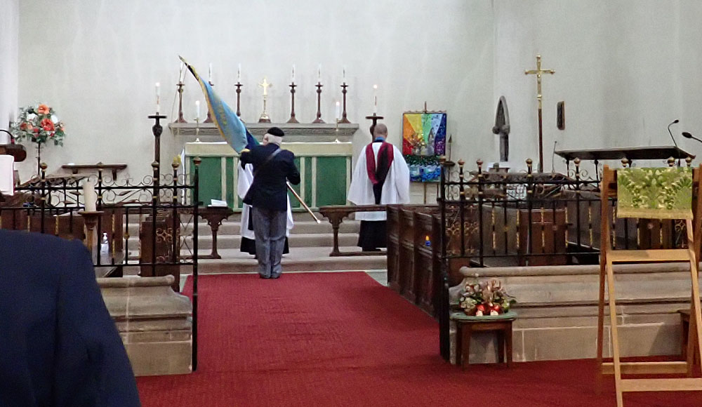 7. The handing over of the Standard, which is placed on the alter.
