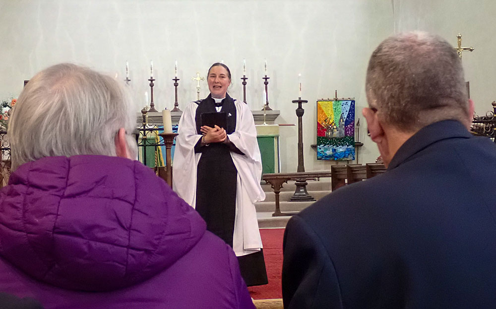 9. Kate welcomes everyone and begins the service.