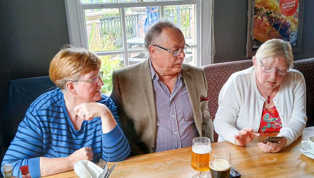 Ros and Ian showing Sylvia how to get the "money off" voucher.