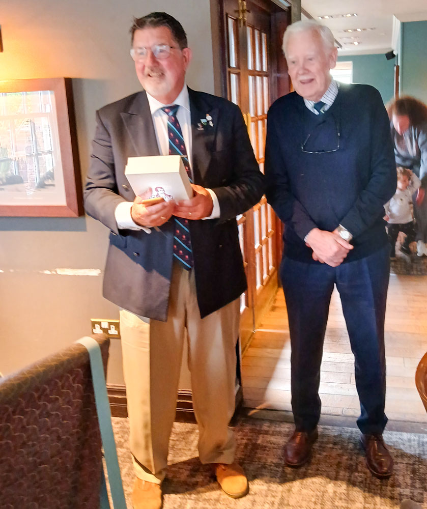 Granville presents John with a gift from the branch